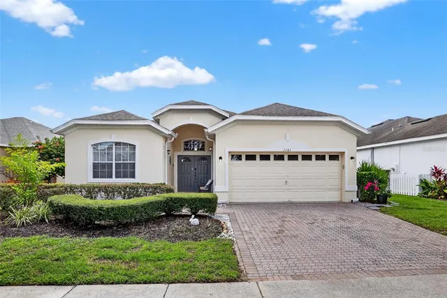 a front view of a house with a garden and plants