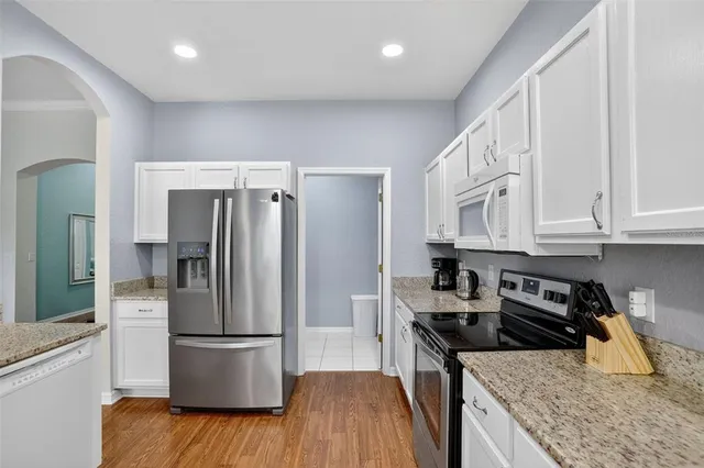 a kitchen with a refrigerator and a sink