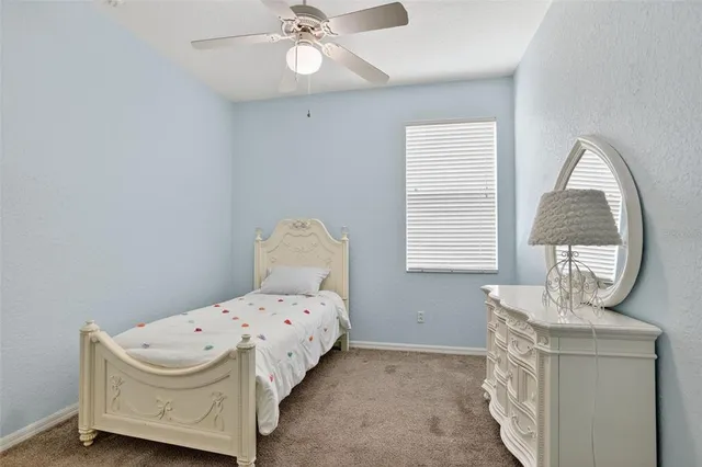 a bedroom with a bed and a mirror