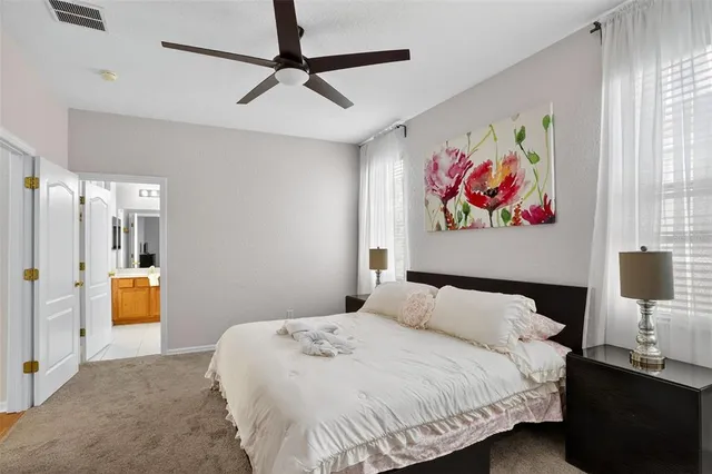 a bedroom with a bed and a painting on the wall