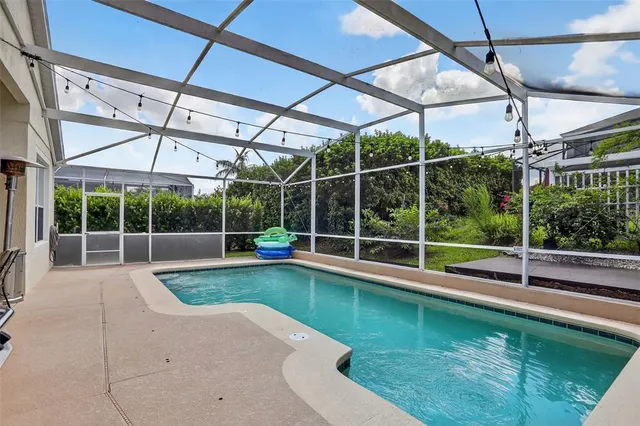 a view of a backyard with a tub and wooden fence