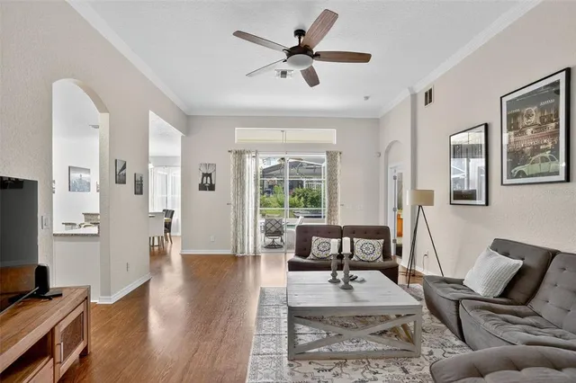 a living room with furniture a rug and a flat screen tv