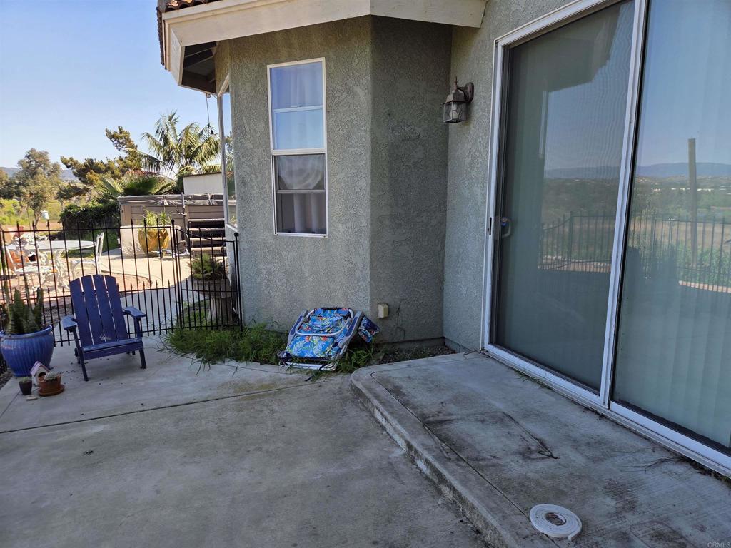 762 Grey Hawk Court Oceanside, CA 92057 - Photo 7 of 14 a backyard of a house with table and chairs