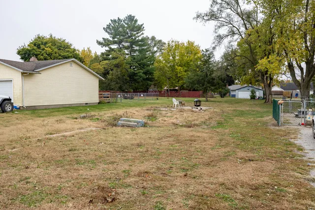 a backyard of a house with table and chairs