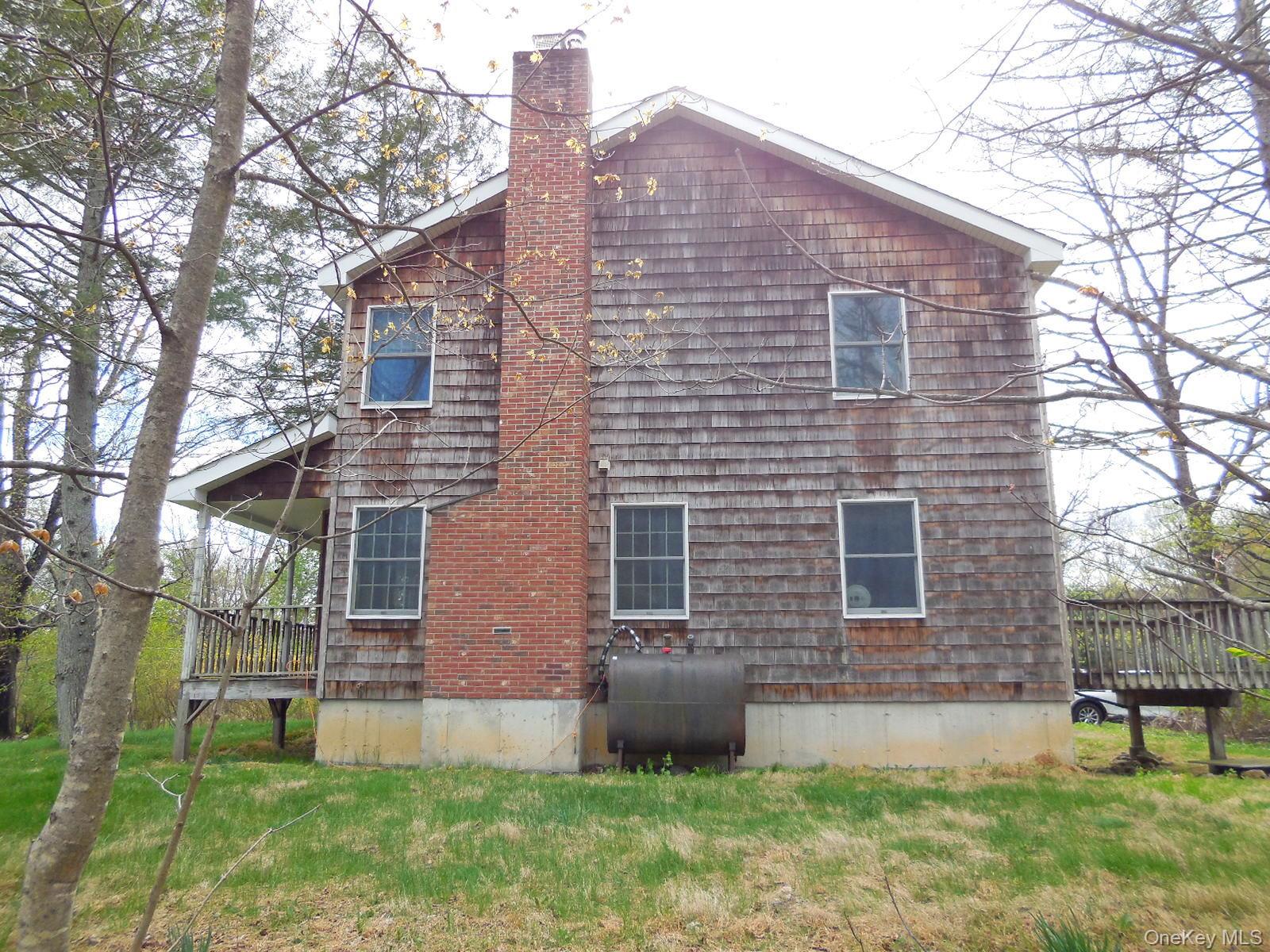 617 Burlingham Road Bloomingburg, NY 12721 - Photo 26 of 39 Right side of home, covered front porch, rear deck, new oil tank.