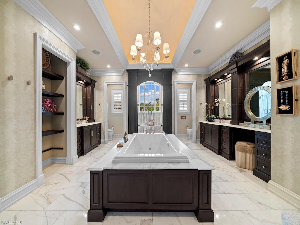 563 3rd Street North Naples, FL 34102 - Photo 12 of 15 a kitchen with stainless steel appliances kitchen island granite countertop a refrigerator a stove and a sink with large countertops