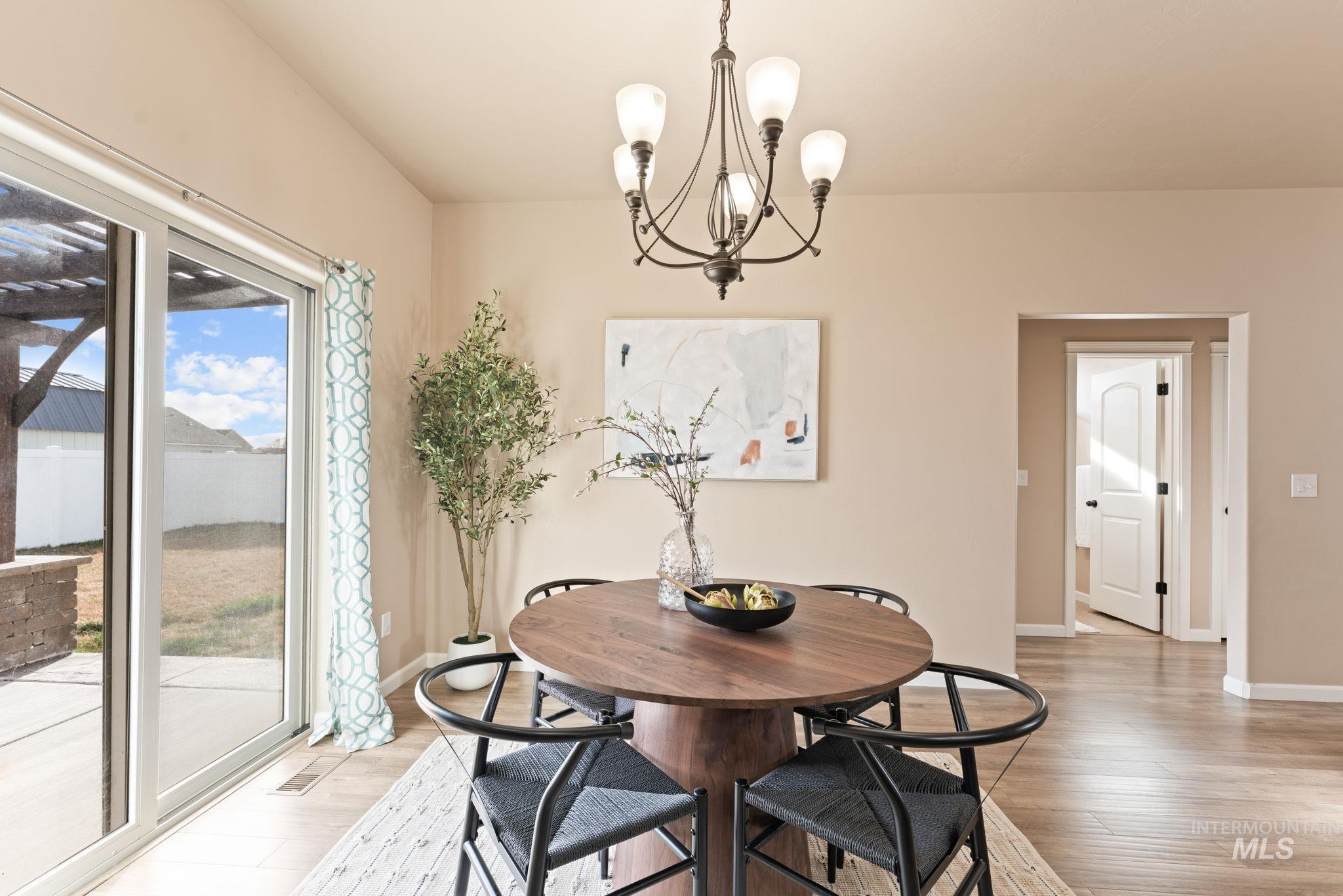 1001 13th Street Rupert, ID 83350 - Photo 13 of 40 Dining room with light wood-type flooring and a chandelier