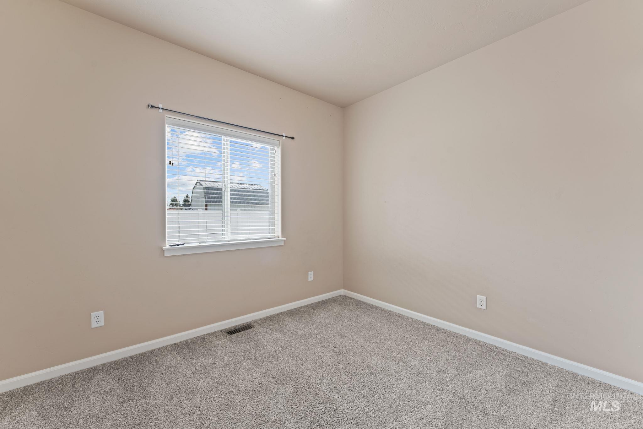 1001 13th Street Rupert, ID 83350 - Photo 24 of 40 Empty room featuring light carpet and baseboards