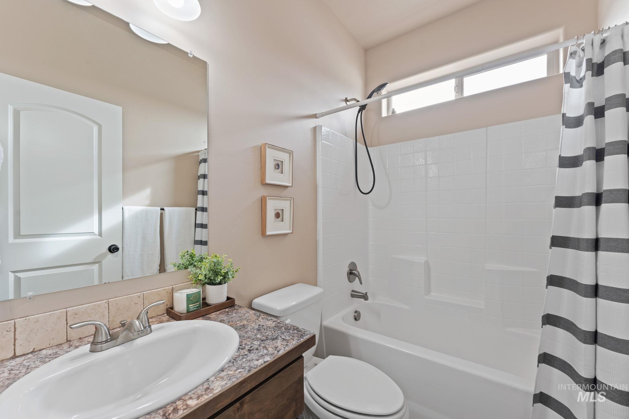 1001 13th Street Rupert, ID 83350 - Photo 26 of 40 Full bathroom featuring vanity and shower / bath combo with shower curtain