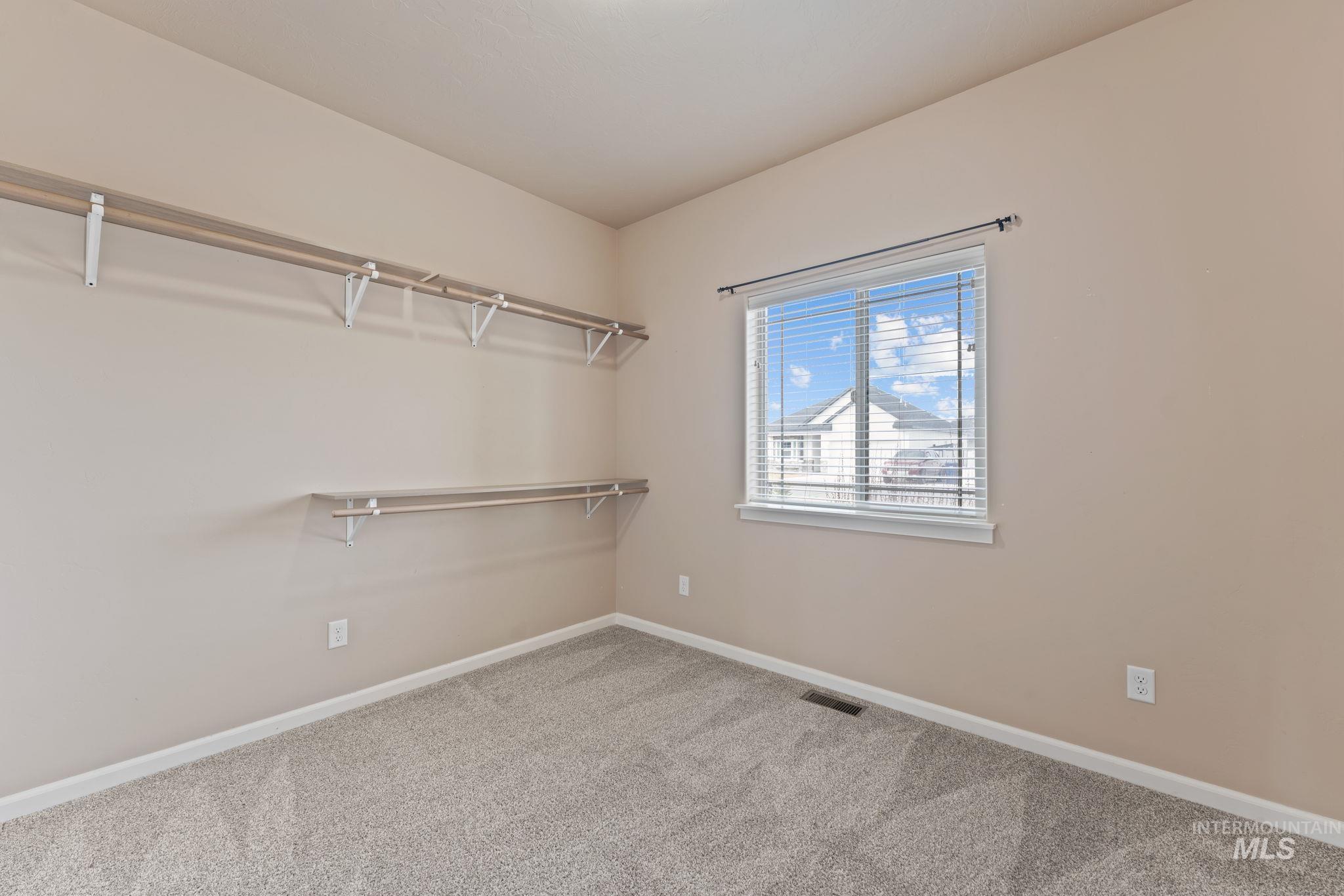 1001 13th Street Rupert, ID 83350 - Photo 28 of 40 Walk in closet featuring light colored carpet