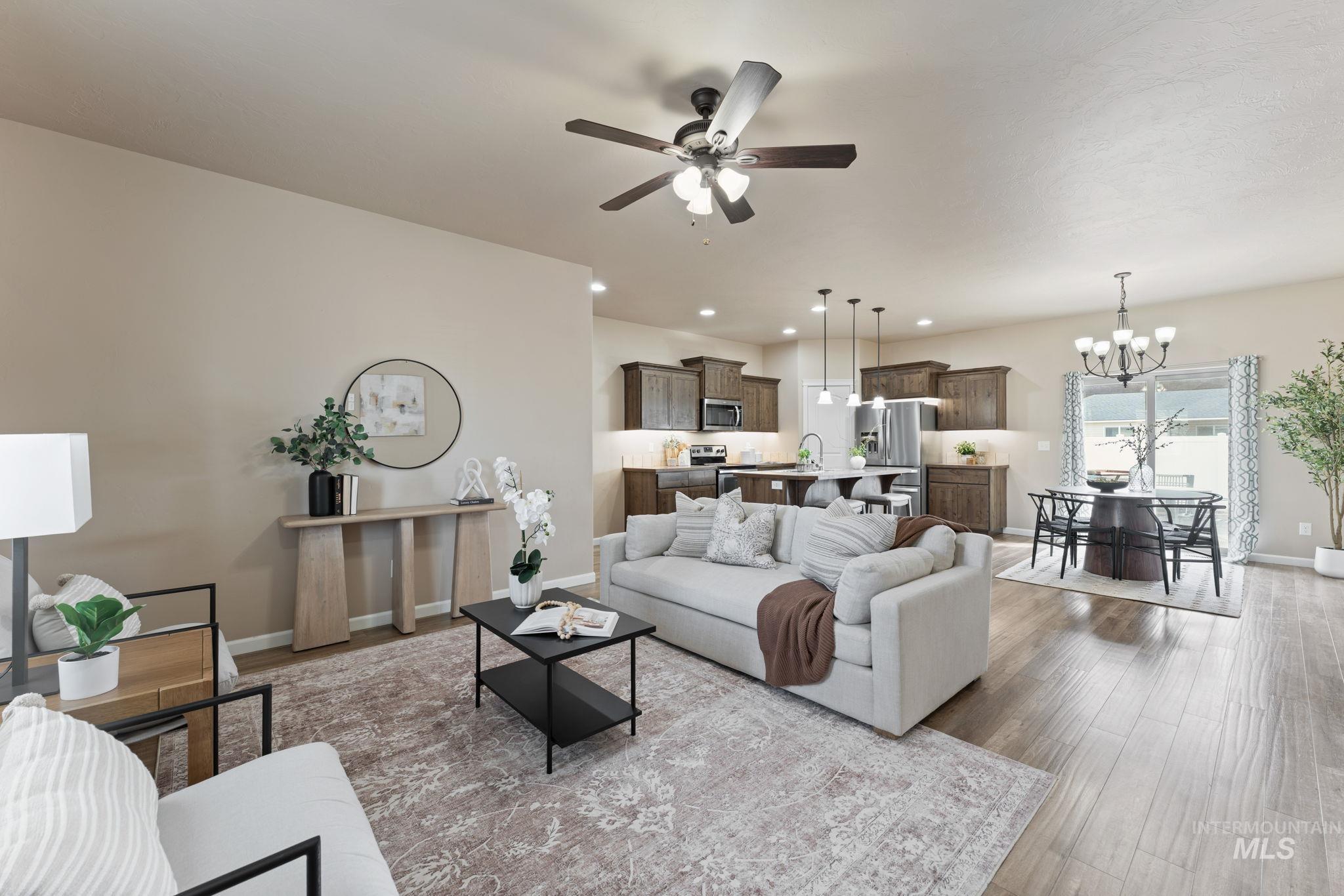 1001 13th Street Rupert, ID 83350 - Photo 3 of 40 Living area with a ceiling fan, a chandelier, and light wood-style flooring