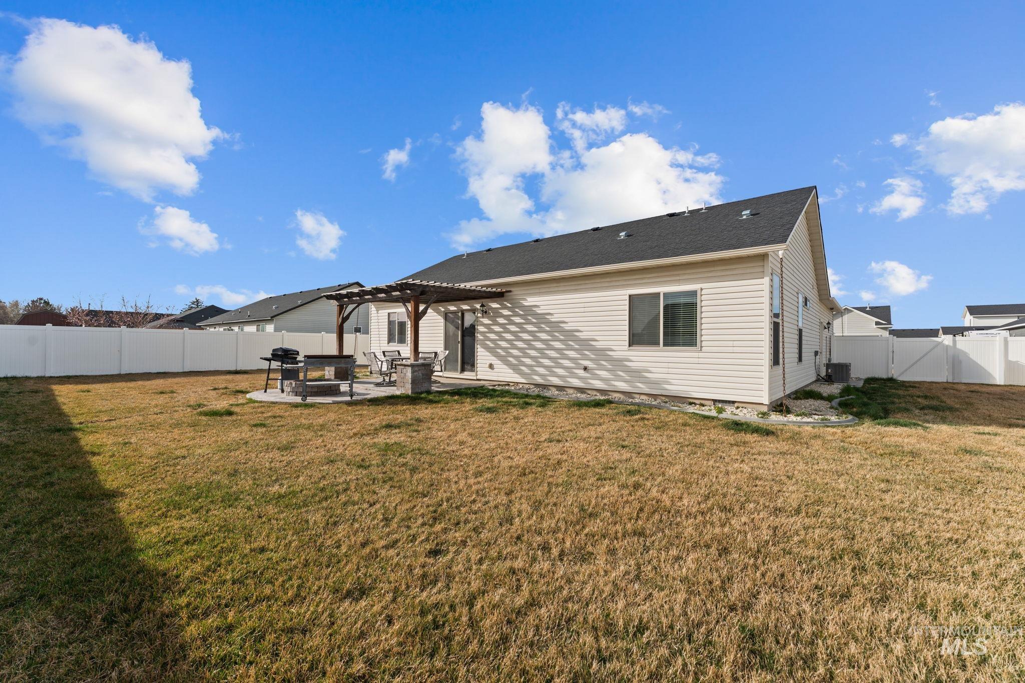 1001 13th Street Rupert, ID 83350 - Photo 32 of 40 Back of property with a patio area, a fenced backyard, and a pergola