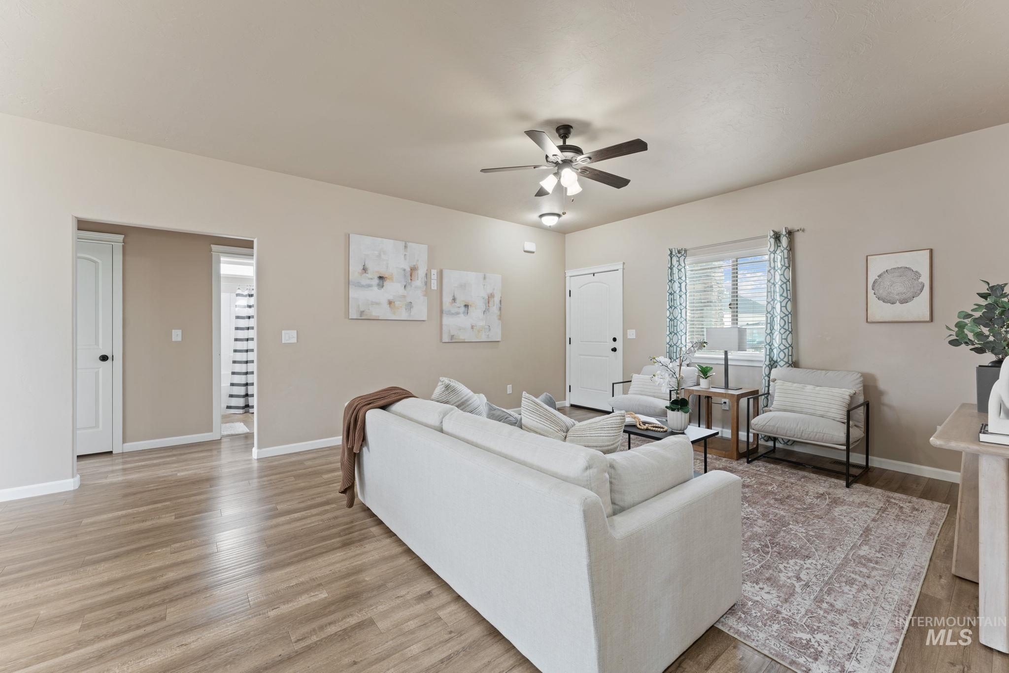 1001 13th Street Rupert, ID 83350 - Photo 6 of 40 Living room featuring ceiling fan and light wood-type flooring