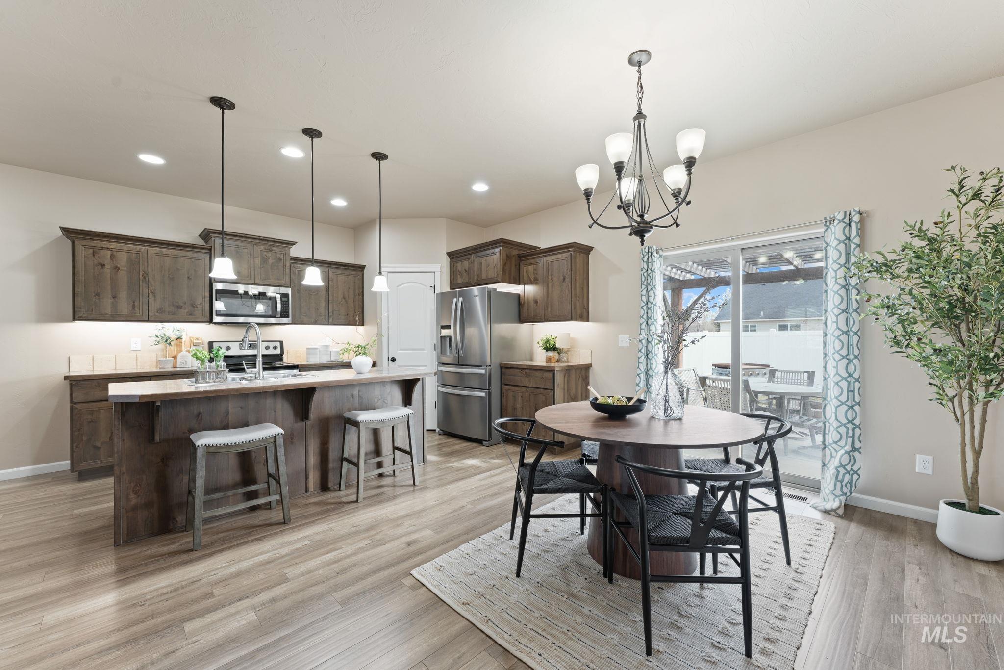 1001 13th Street Rupert, ID 83350 - Photo 7 of 40 Dining area with light wood finished floors and hanging lights
