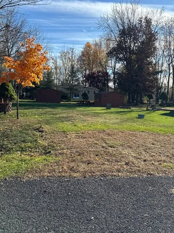 a view of backyard with tub and trees