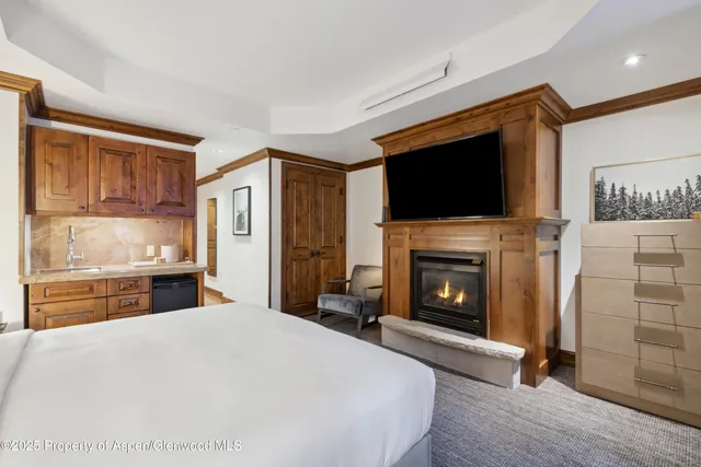 a bedroom with a bed and a fireplace