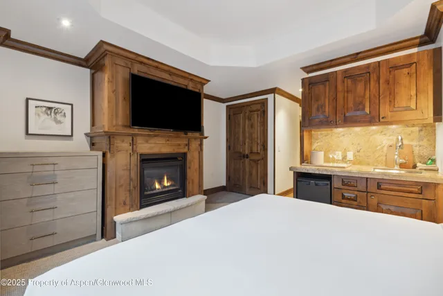 a kitchen with a fireplace and a sink
