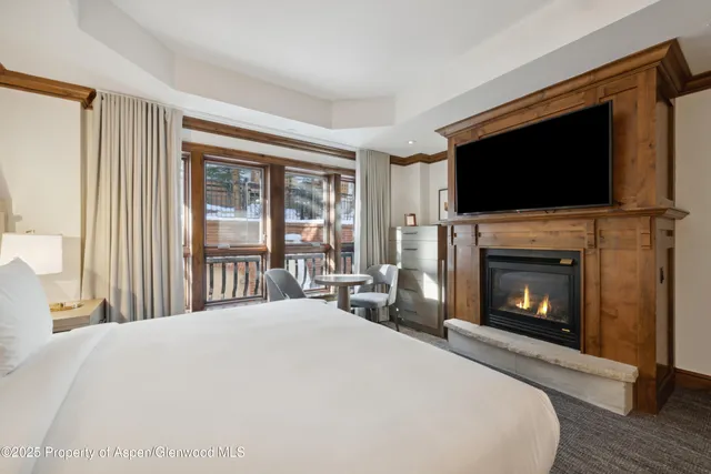a bedroom with a bed and a fireplace