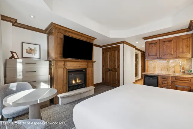 a bedroom with a bed and a fireplace