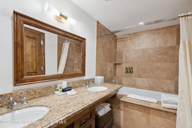 a bathroom with a granite countertop sink mirror and a