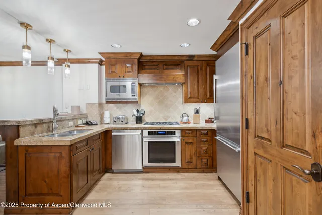 a kitchen with stainless steel appliances granite countertop a stove and a sink