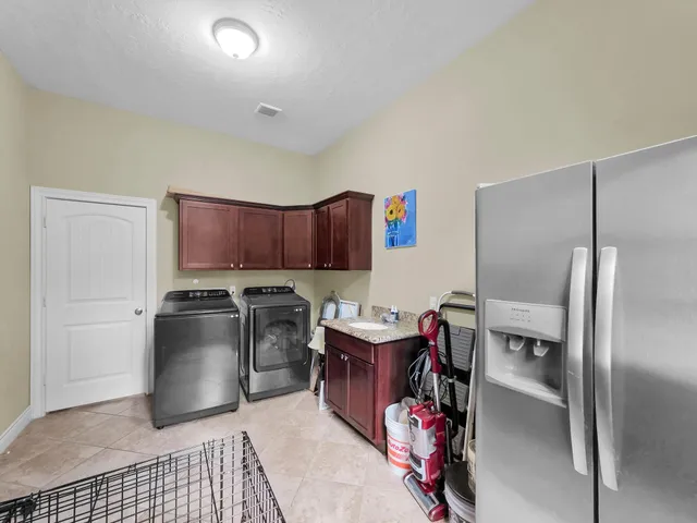 a bedroom with a bed and a flat tv screen on dresser