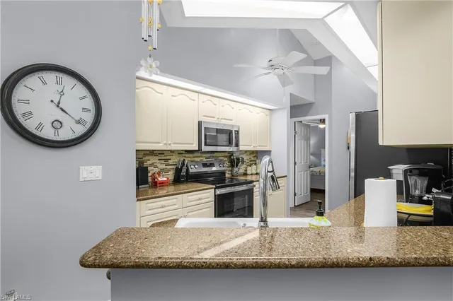 a kitchen with a refrigerator a stove top oven a sink and dishwasher