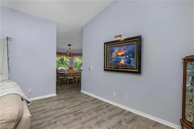 a view of a hallway with wooden floor and a workspace