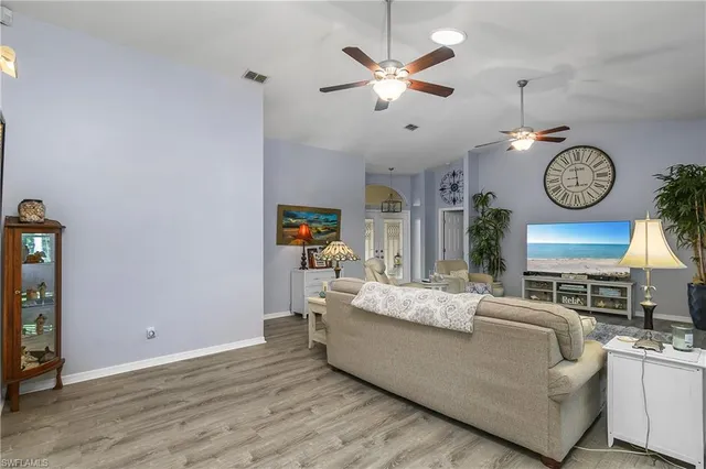 a living room with furniture a clock and a window