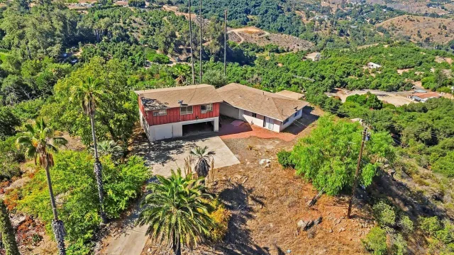 an aerial view of a house with yard and outdoor seating