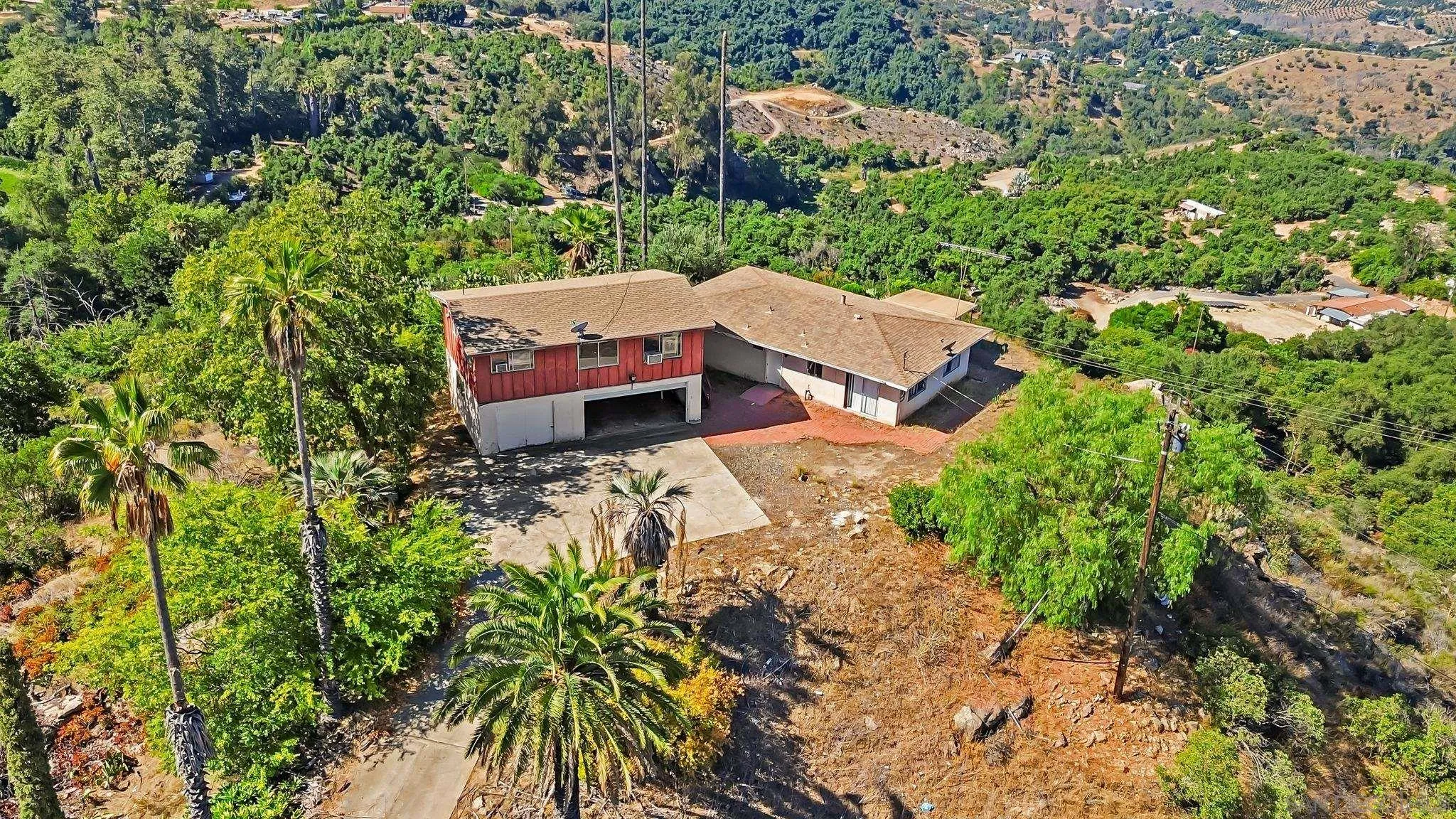 an aerial view of a house with yard and outdoor seating