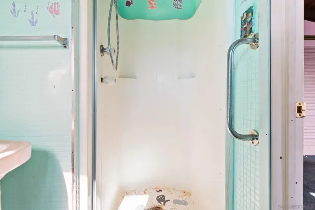 a kitchen with a refrigerator and a sink