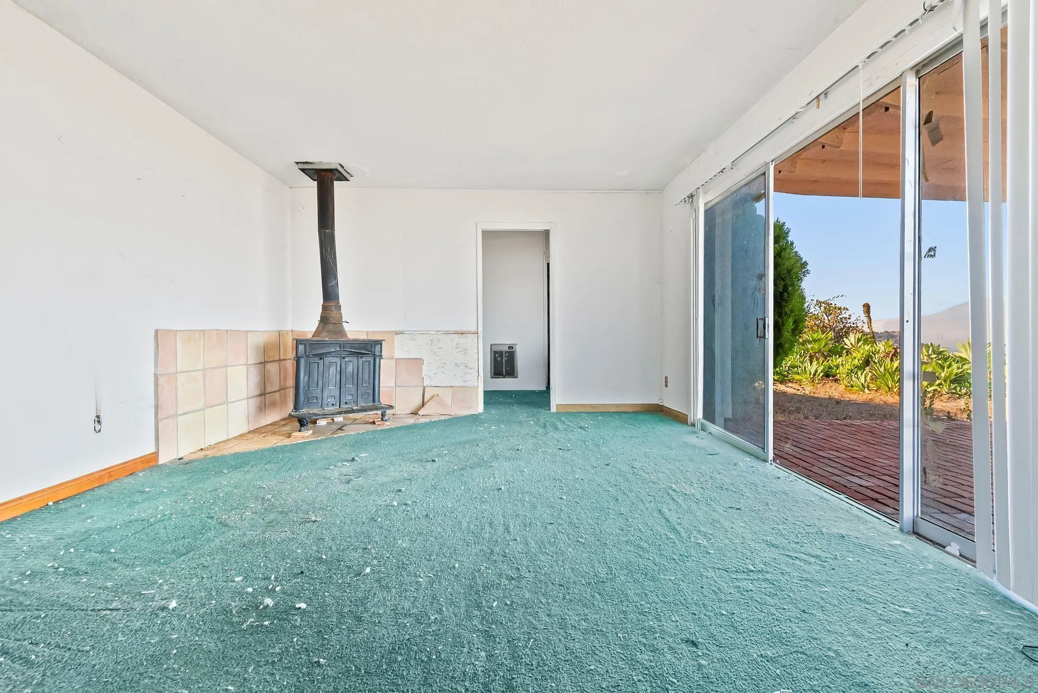6133 Rainbow Heights Road Fallbrook, CA 92028 - Photo 30 of 55 a view of a room with floor to ceiling windows and potted plants