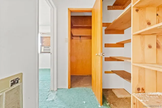 a view of small space with wooden floor and a window
