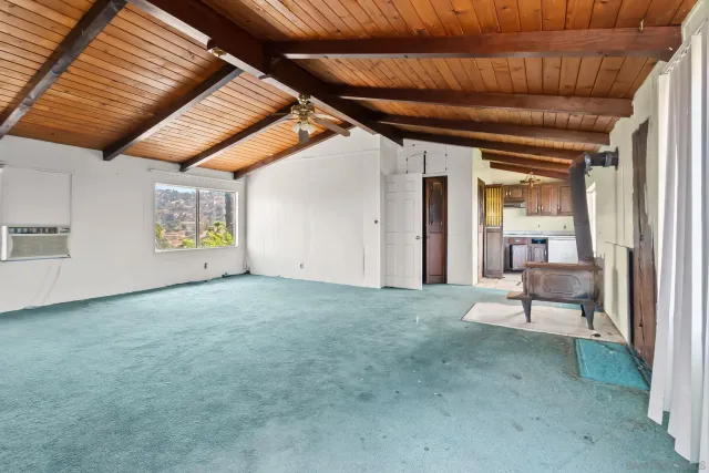 a view of an empty room with a fireplace