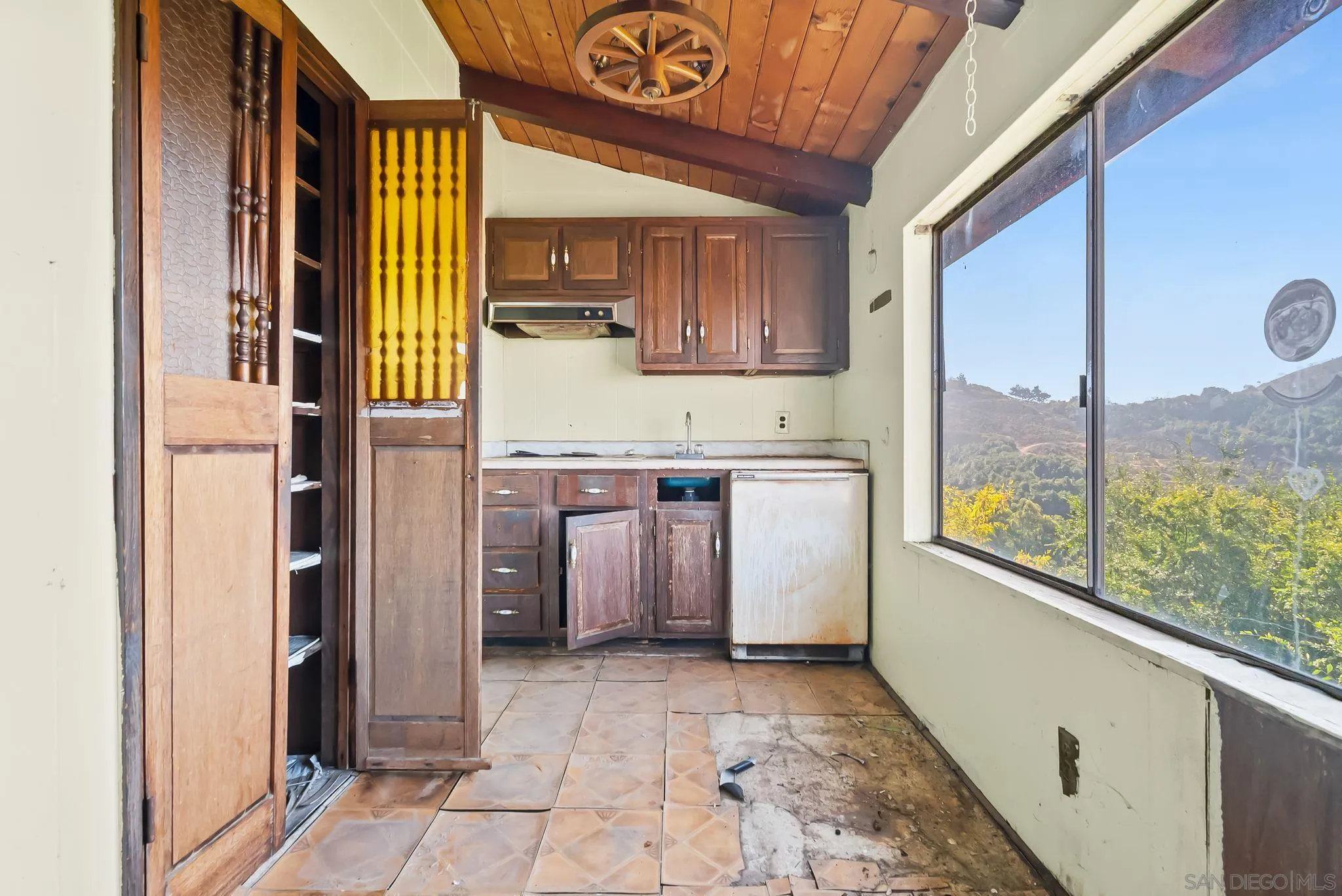 6133 Rainbow Heights Road Fallbrook, CA 92028 - Photo 8 of 55 a view of a kitchen with a fridge and window