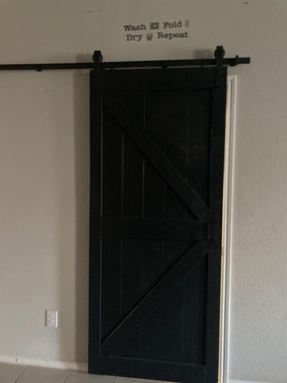 7416 Boat Wind Road Fort Worth, TX 76179 - Photo 8 of 18 Barn-style door to the utility room