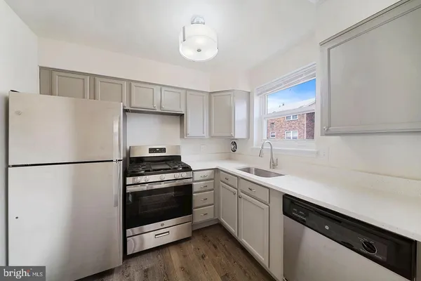 a kitchen with a white cabinets and white appliances