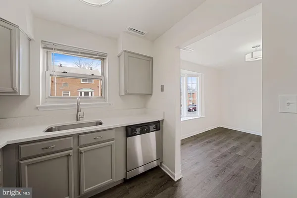 a kitchen with a sink cabinets and a window