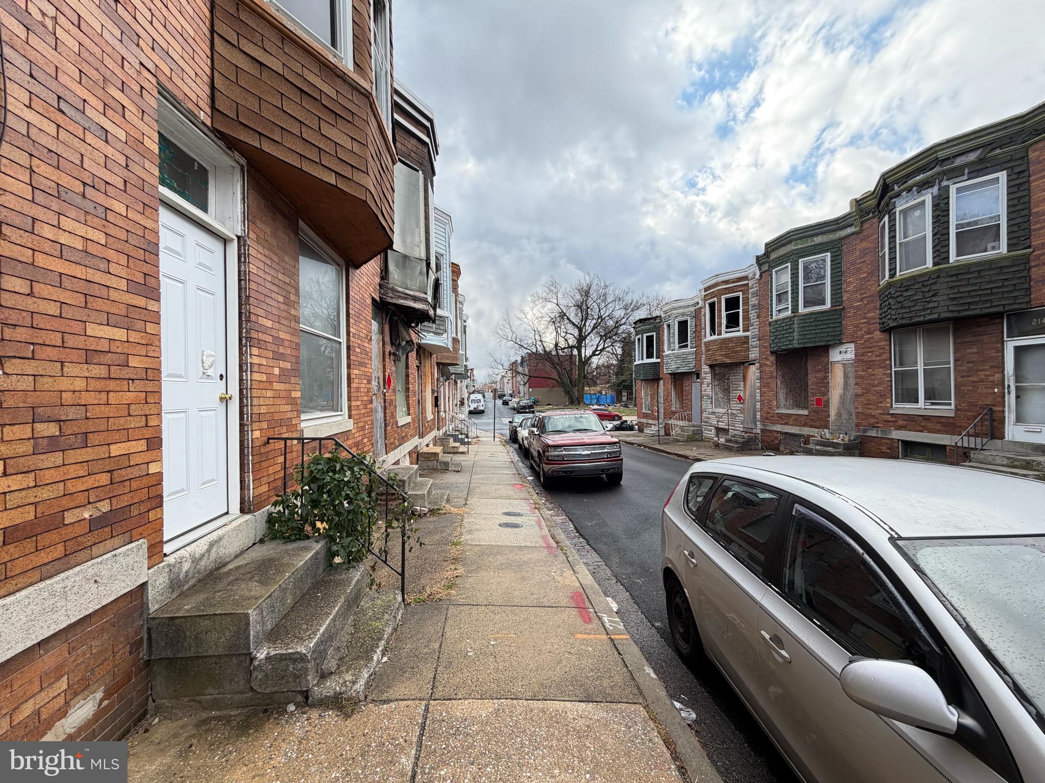 213 Furrow Street Baltimore, MD 21223 - Photo 2 of 19 a view of a city that has couple of cars parked in front of it