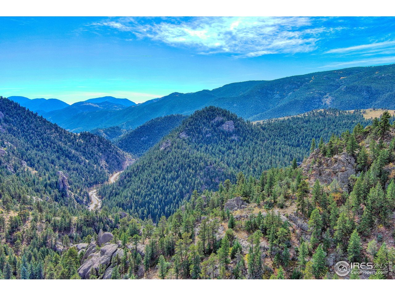 10697 County Road 43 Drake, CO 80515 - Photo 1 of 34 a view of a lush green hillside and a building
