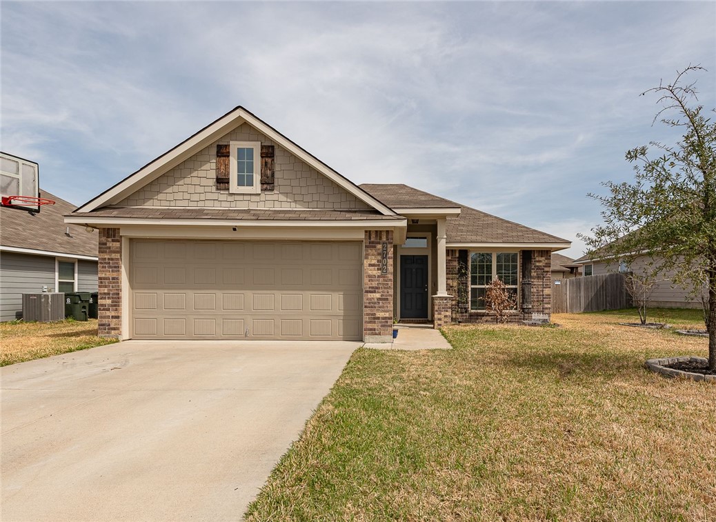 2702 Redcap Street Bryan, TX 77803 - Photo 1 of 17 a front view of a house with a yard and garage