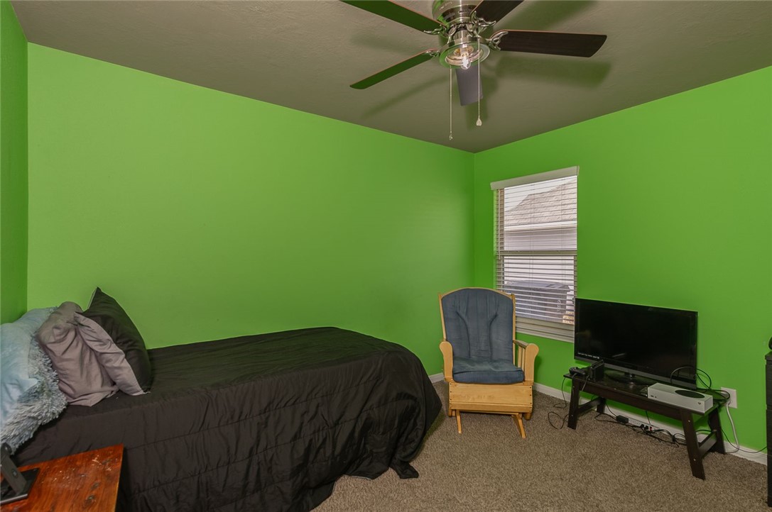 2702 Redcap Street Bryan, TX 77803 - Photo 11 of 17 a bedroom with a bed and a chandelier