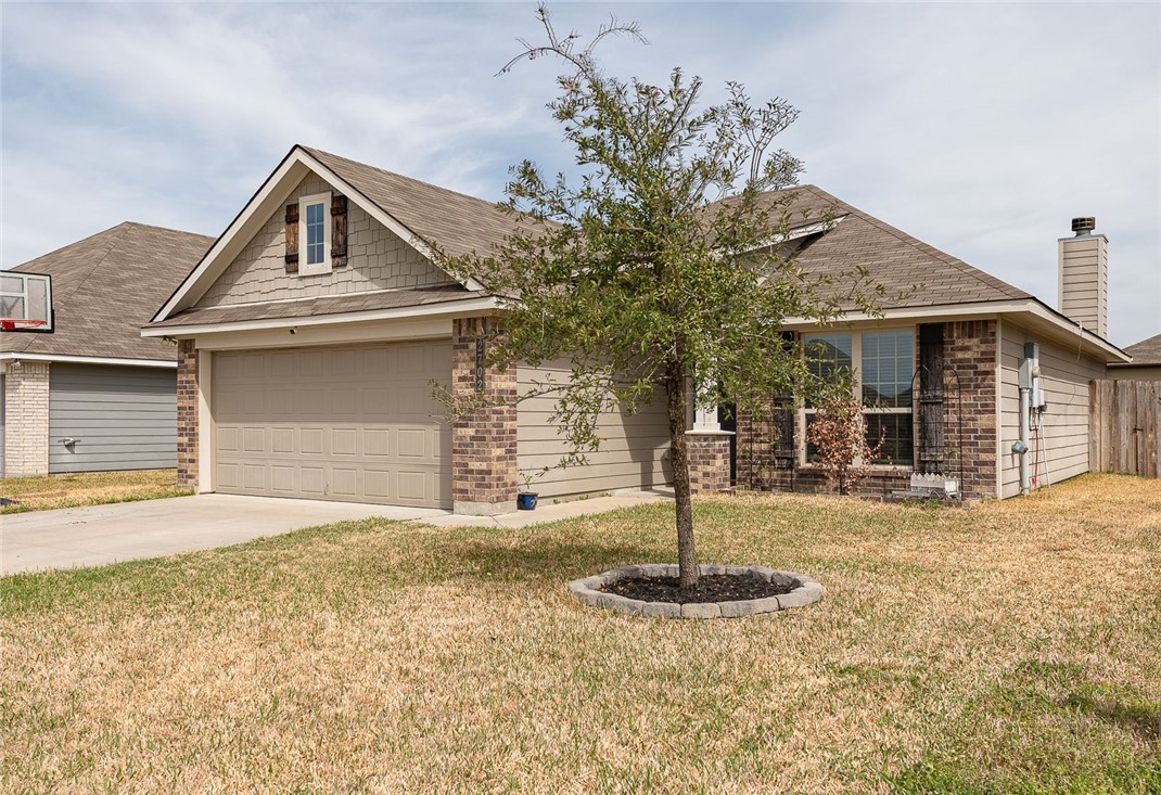 2702 Redcap Street Bryan, TX 77803 - Photo 2 of 17 a front view of a house with a yard garage and window