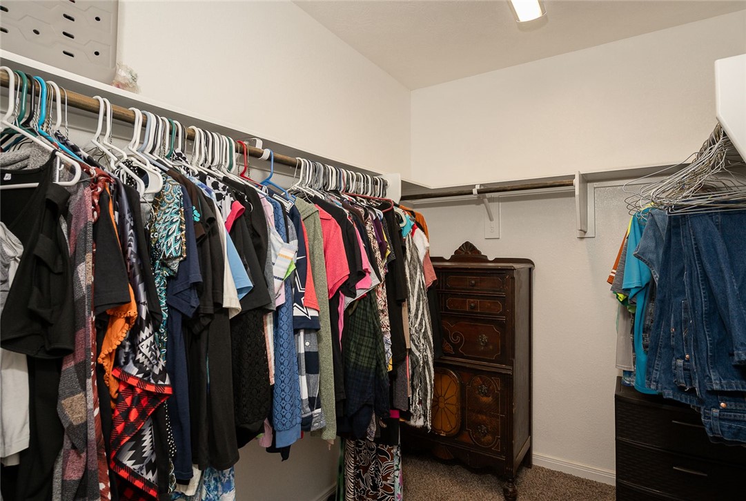 2702 Redcap Street Bryan, TX 77803 - Photo 8 of 17 a view of walk in closet with clothes and shoes