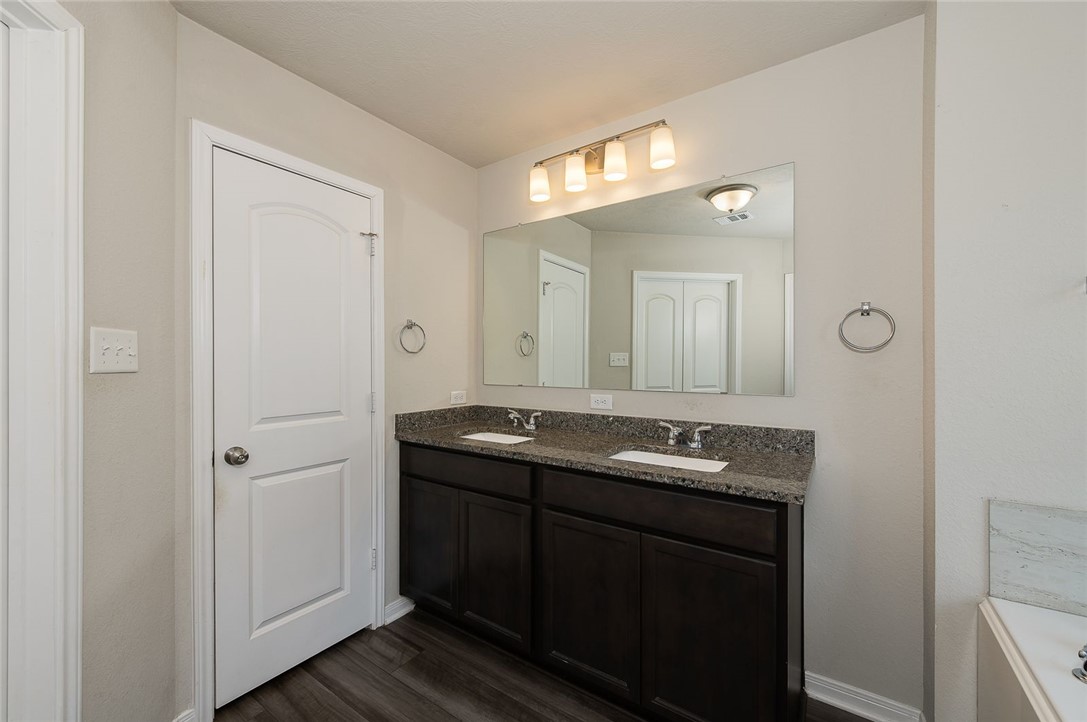 2702 Redcap Street Bryan, TX 77803 - Photo 9 of 17 a bathroom with double sink and a mirror