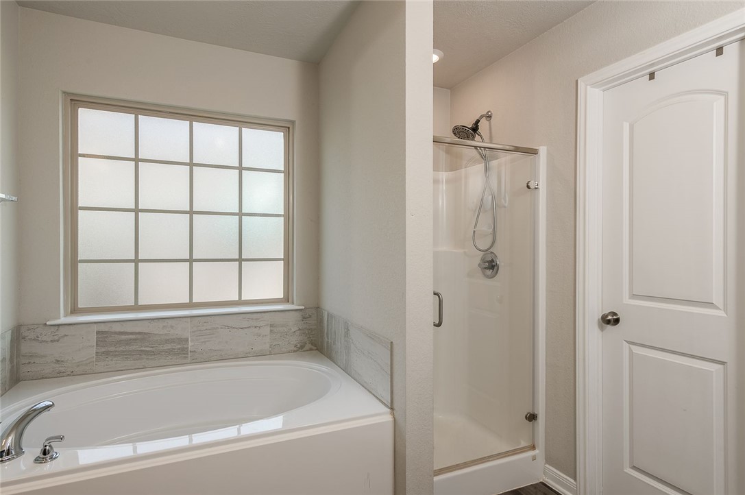 2702 Redcap Street Bryan, TX 77803 - Photo 10 of 17 a bathroom with a bathtub and shower