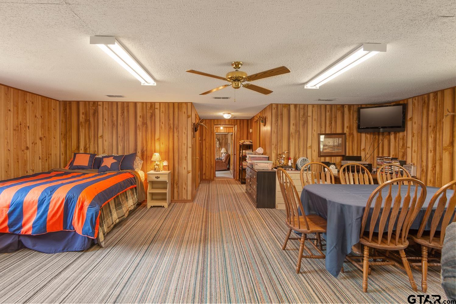 821 Gorman Oaks Road Big Sandy, TX 75755 - Photo 24 of 35 a bedroom with a bed and a table