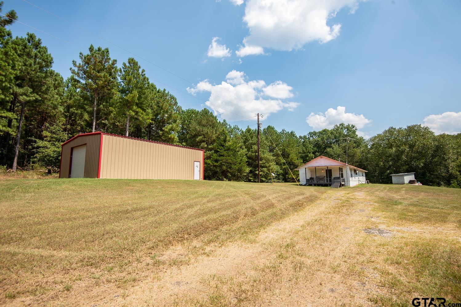 821 Gorman Oaks Road Big Sandy, TX 75755 - Photo 27 of 35 a big house with a big yard and large trees