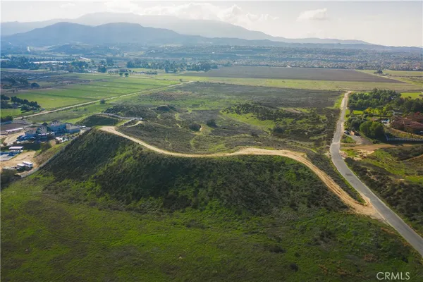 a view of a field with an ocean